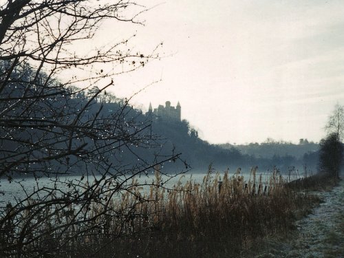 Alton Castle, viewed from far bank of river Churnet on a winter morning