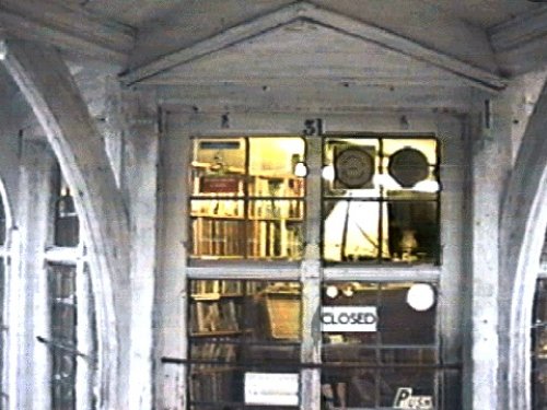 Peaking inside the window of Lankester Books and Antiques.  Saffron Walden, Essex.