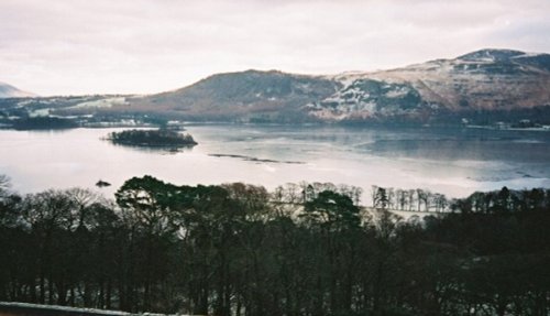 A frozen Derwent Water from the fell side path below Cat Bells Derwent , Cumbria