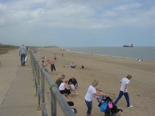 Ingoldmells beach with a ship doing work in the sea.