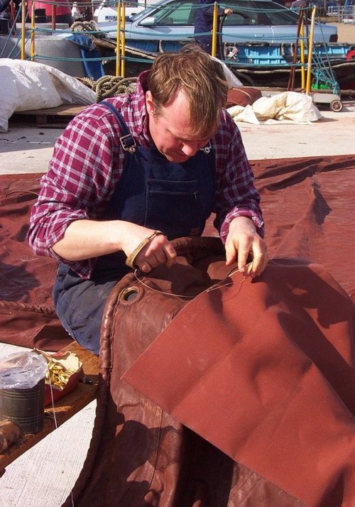 Repairing a sail at Maldon's busy boatyard.