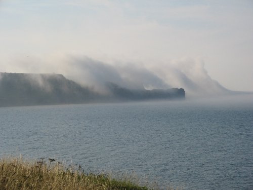 Sea mist rises over Sandsend Ness, Whitby, North yorks