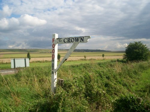 Fingerpost pointing to one of the pubs at Broad Hinton, Wiltshire