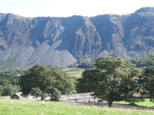Gentle farmland of lower Wasdale with the dramatic backdrop of the screes.