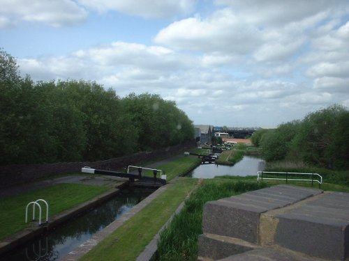 Twelve step lock stairway in Oldbury, West Midlands, carrying canal beneath M5 near junction 2.