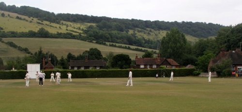 Cricket game with Box Hill in the background in Dorking, Surrey July 2006