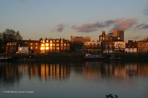 London River Thames, Hammersmith, evening light on the riverside with reflections.