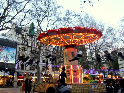 Leicester Square Christmas Fair, London, Greater London, The Chairs (Charlie Chaplin looking on).