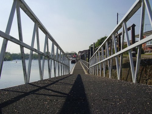 Footway leading to boats/barges moored at the side of the River Trent at Beeston, Nottinghamshire.