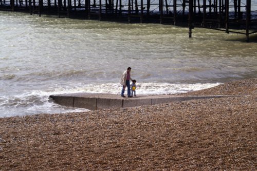 Father and son on Hastings beach.