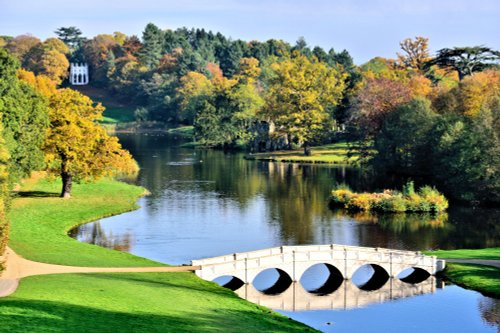 Autumn View of the 5 Arch Bridge & Gothic Temple at Painshill Park in Cobham, Surrey