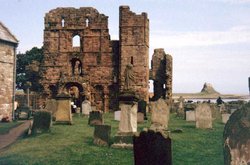 The ruins of Lindisfarne Abbey with Lindisfarne Castle in the distance.