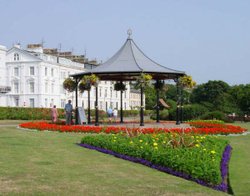 A View of the bandstand with the Victorian buildings of the Crescent in the background Wallpaper