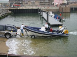 A boat being launched from the new slip Wallpaper