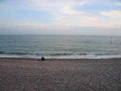 A fisherman along the seafront at West Bay, Dorset Wallpaper