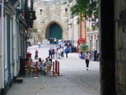 Local types have a drink while tourists take in the sights at the top of cobbled Steep Hill. Wallpaper