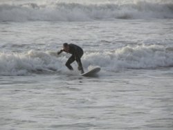 AUTUMN DAY WITH A LONE SURFER 2005 IN THE SEA AT TYWYN, WALES Wallpaper