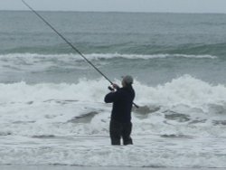 Sea fishing for bass on Tywyn beach, summer 2005. Wallpaper