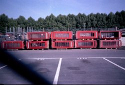 Taunton's old BT yard piled up with discarded Phone boxes. Wallpaper