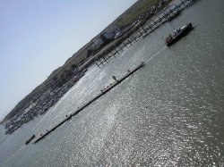 Moving pontoons to allow for dredging on the river Arun Littlehampton. Wallpaper