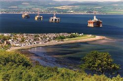 View of the Oil Rigs in the Cromarty Firth looking over the village of Cromarty Wallpaper