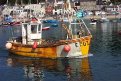 Fishing boat leaves harbour at Lyme Regis. Wallpaper