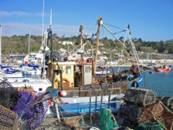 A trawler making ready to go to sea, from the Cobb harbour at Lyme Regis, Dorset. Wallpaper