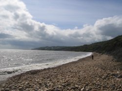 Clouds seeming to mimic the curves of the bay at Charmouth, Dorset Wallpaper