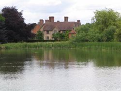 Packwood House, Warwickshire. Looking towards the house from across the pool Wallpaper