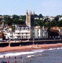 The Church at Teignmouth, showing swimmers enjoying a summer break.