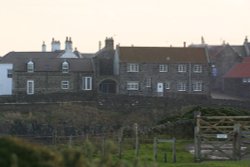 Houses overlooking Craster Harbour and Craster Village Northumberland. Wallpaper