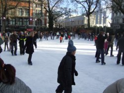 A Christmas skating session in the gardens of the Natural History Museum, London. Wallpaper