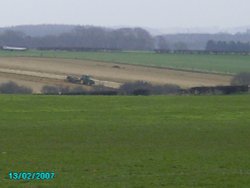 Looking out of Worksop towards the North. Tractors busy in this rural area Wallpaper