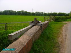 An old sluice gate to control the water flow around the fields in Littleborough in Nottinghamshire Wallpaper