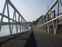 Footway leading to boats/barges moored at the side of the River Trent at Beeston, Nottinghamshire. Wallpaper