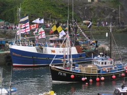 Bunting decorates the boats in Mevagissey Harbour, Cornwall