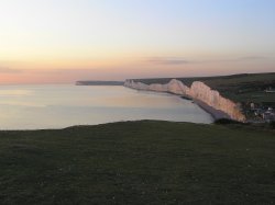 The Seven Sisters bathed in pink light at sunset, seen from Birling Gap Wallpaper