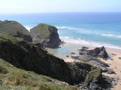 The tide leaves blue pools of water on the beach at Bedruthan Steps, Cornwall Wallpaper