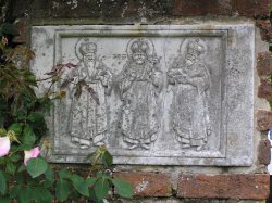 A wall plaque of three kings at Sissinghurst castle gardens Wallpaper