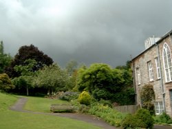 Stormy clouds over Cockington Manor. Wallpaper