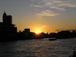 The London skyline at sunset, seen from a river boat Wallpaper