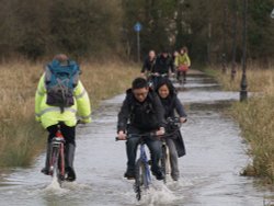 Cyclists in floodwater, the Parks, Oxford