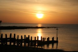 Sunset and Starlings massing over the sea