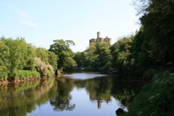 A view of Warkworth Castle from the river bank