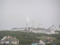 The beam of Lizard lighthouse reflects off the fog Wallpaper