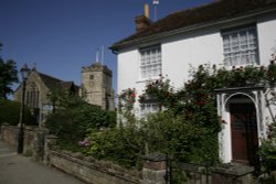 Cottage in village with  flowers and Church Wallpaper