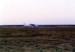 Plane landing at the airstrip. Wallpaper