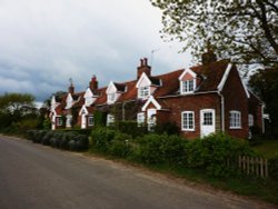 Cottages on the side of a very narrow country road Wallpaper