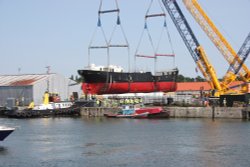 1890 S.S. Robin being lifted onto a pontoon