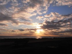 Clouds and setting sun Wallpaper